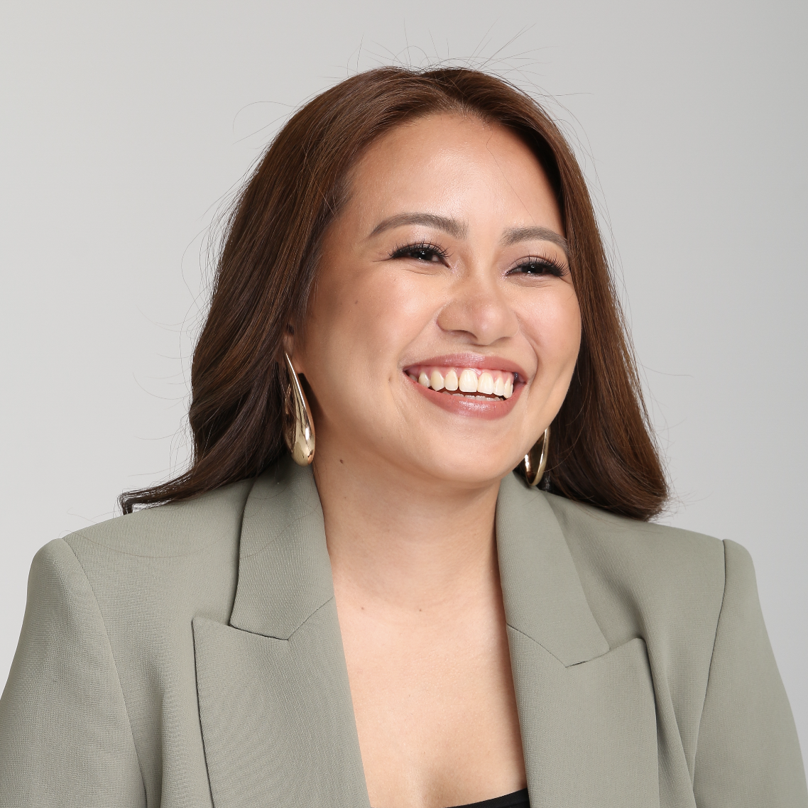 Charlene Ormo smiling in green blazer